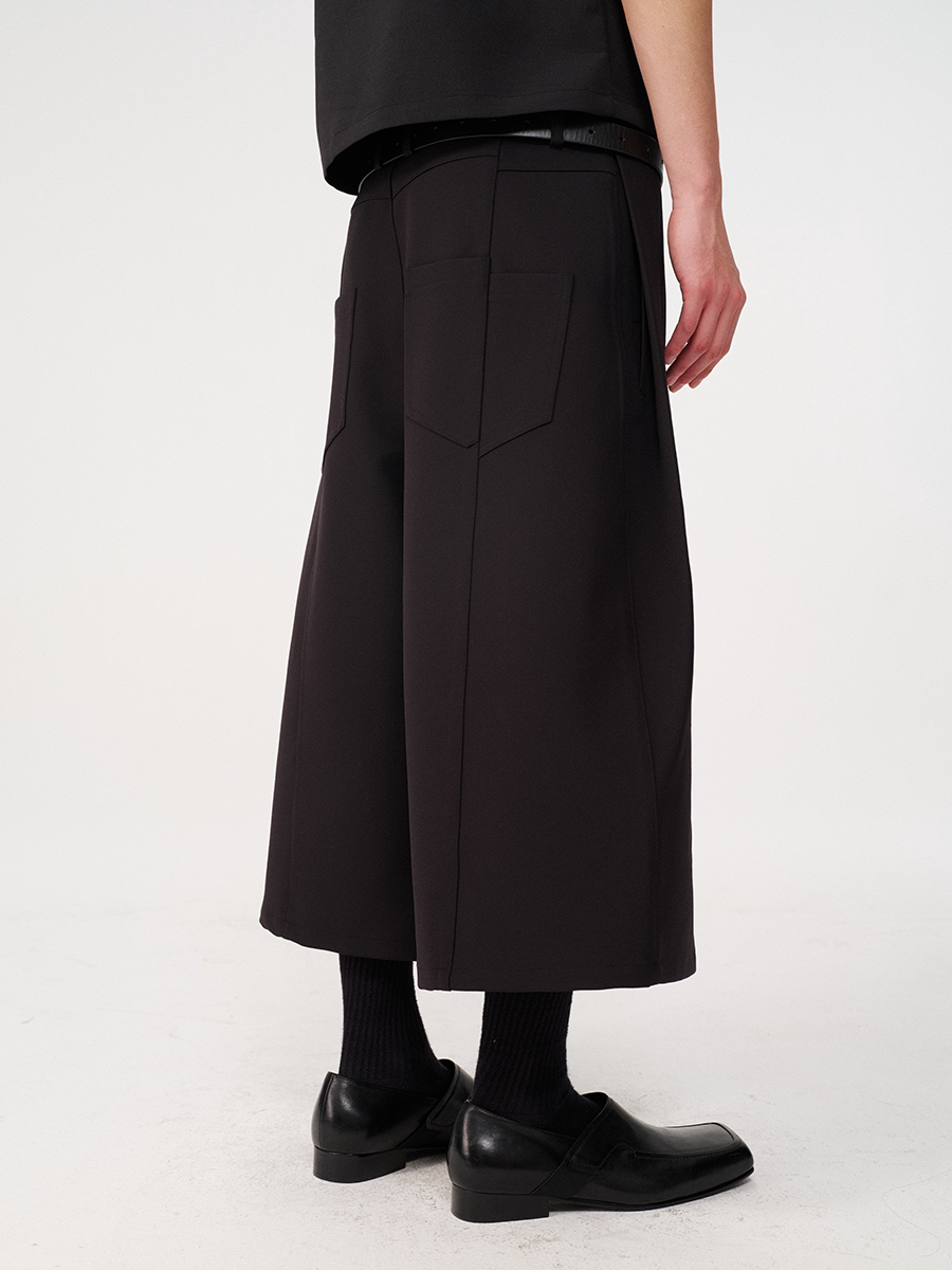 CURVED PLEATED PANTS