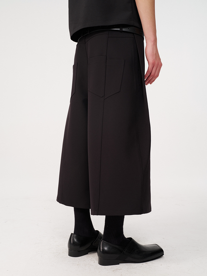 CURVED PLEATED PANTS
