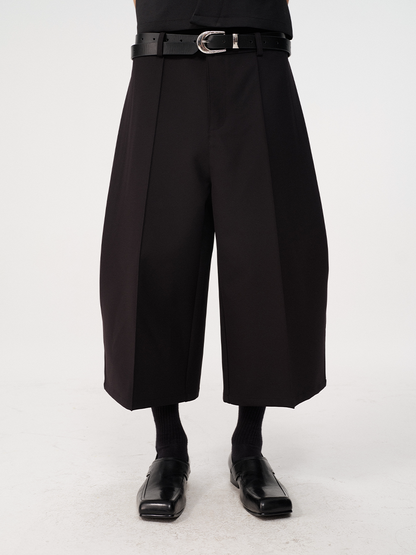 CURVED PLEATED PANTS
